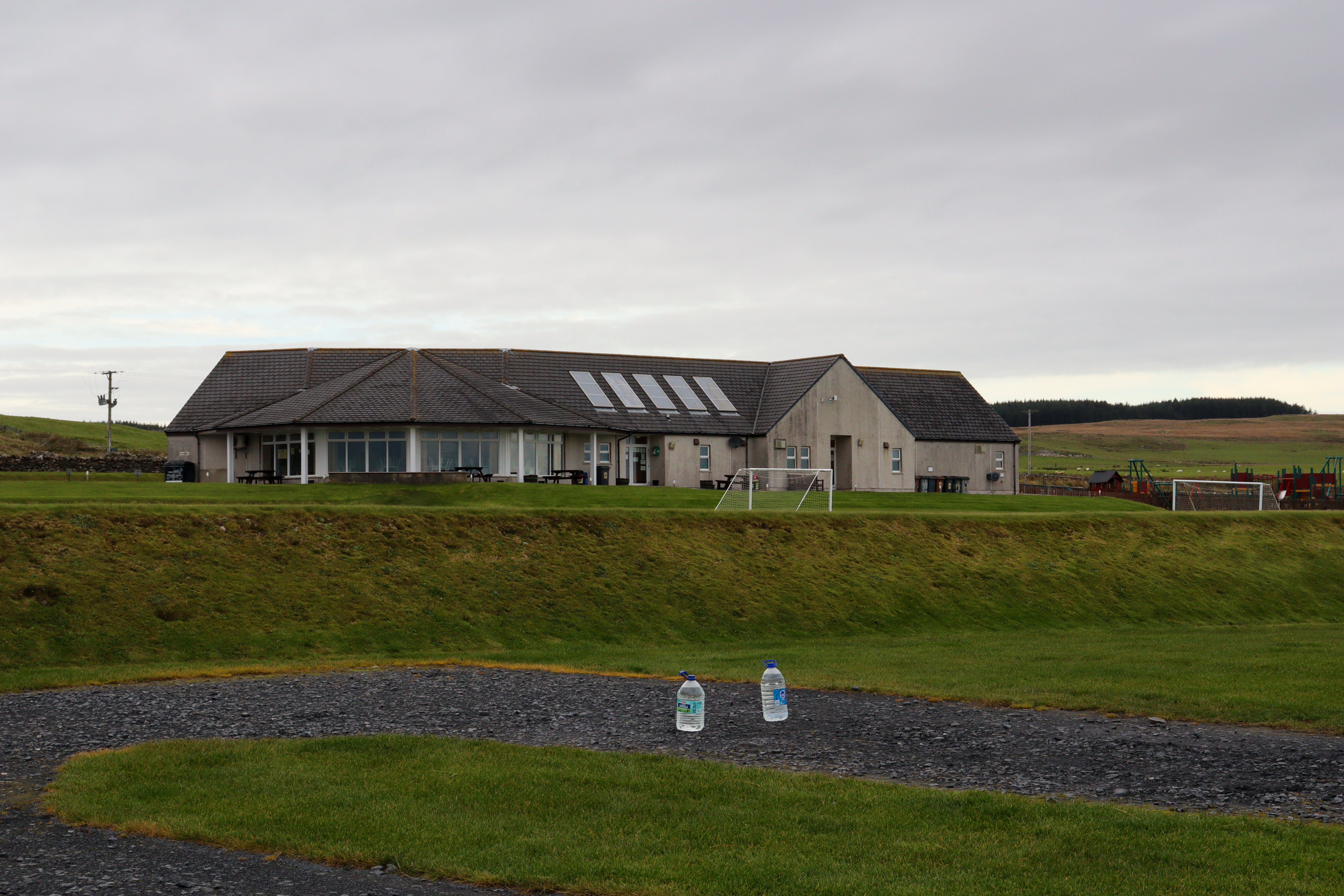 Large field with a building on the other side.