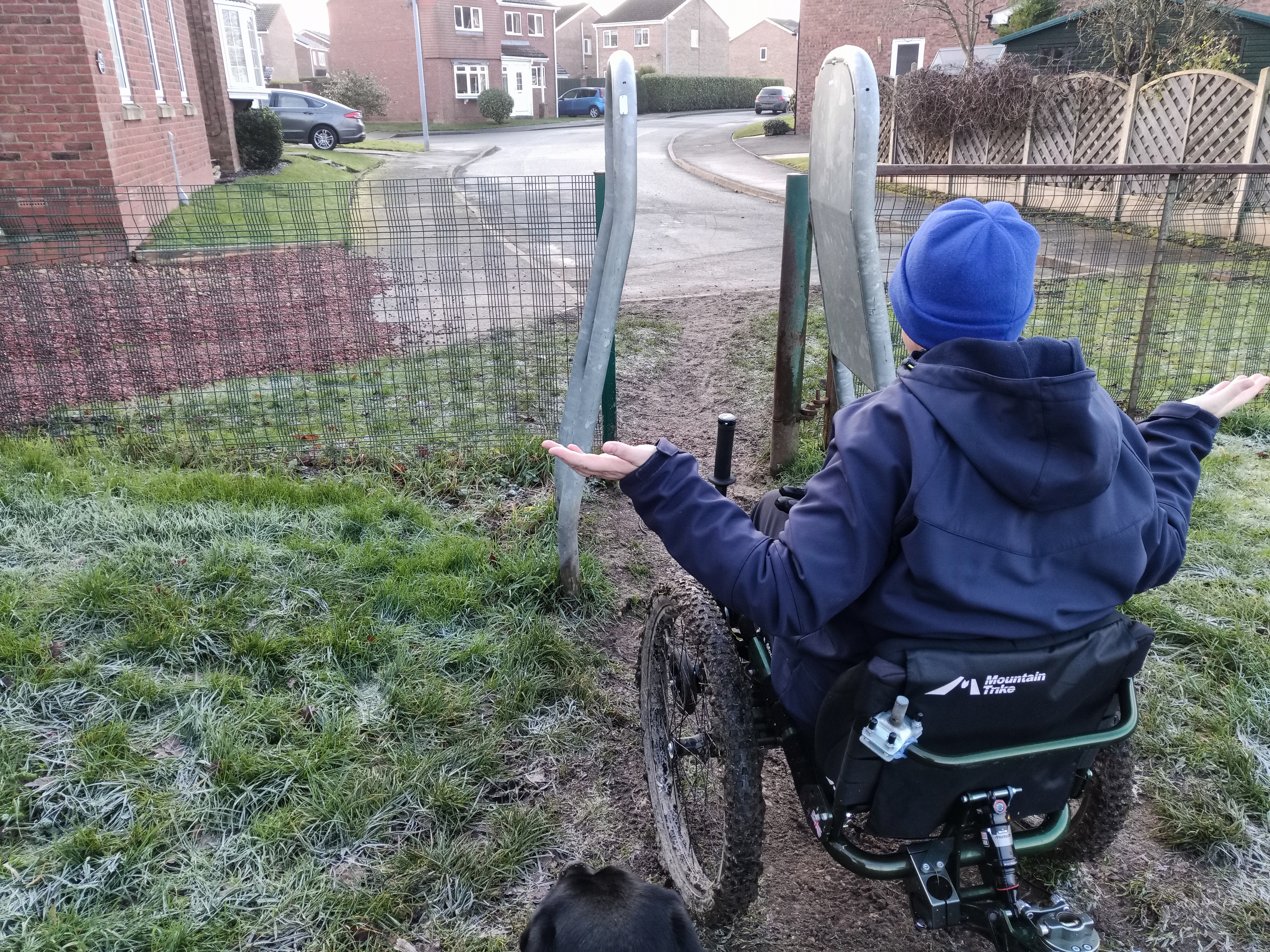 Person in a wheelchair in front of an A-frame that prevents access.